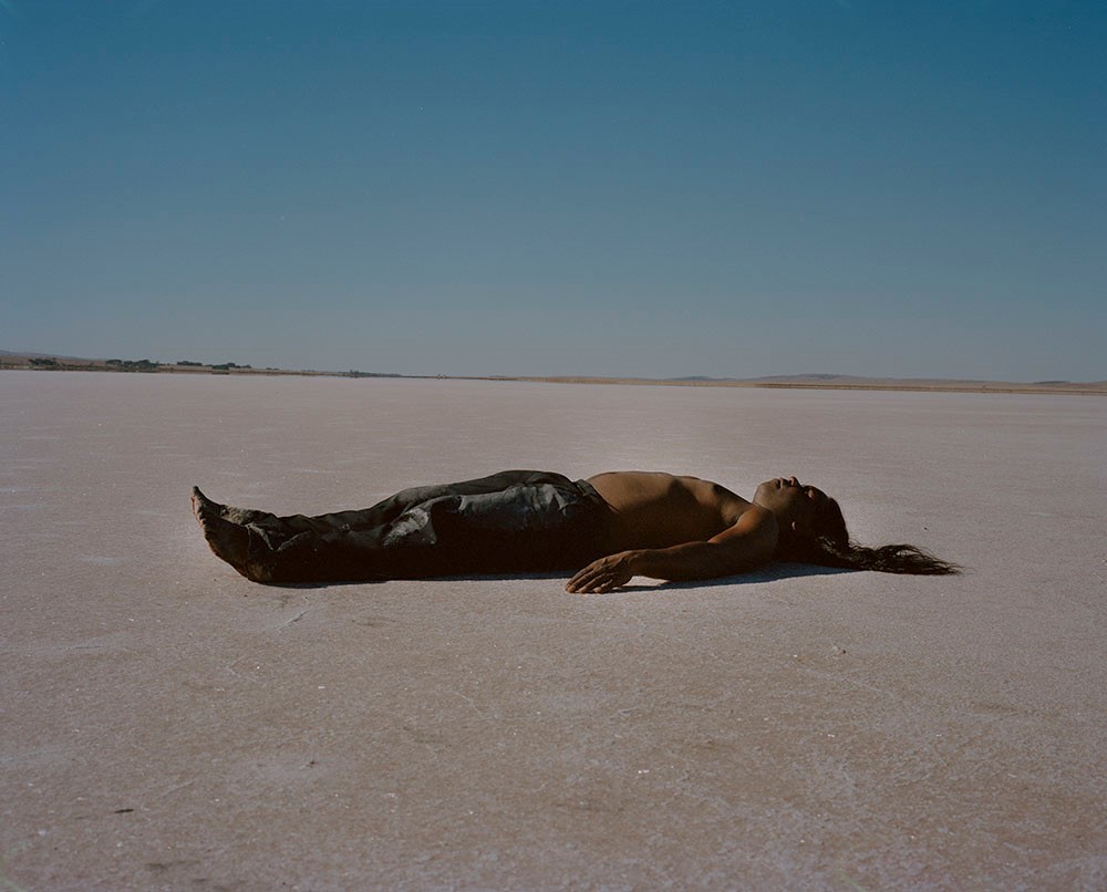 man lying on a salt lake